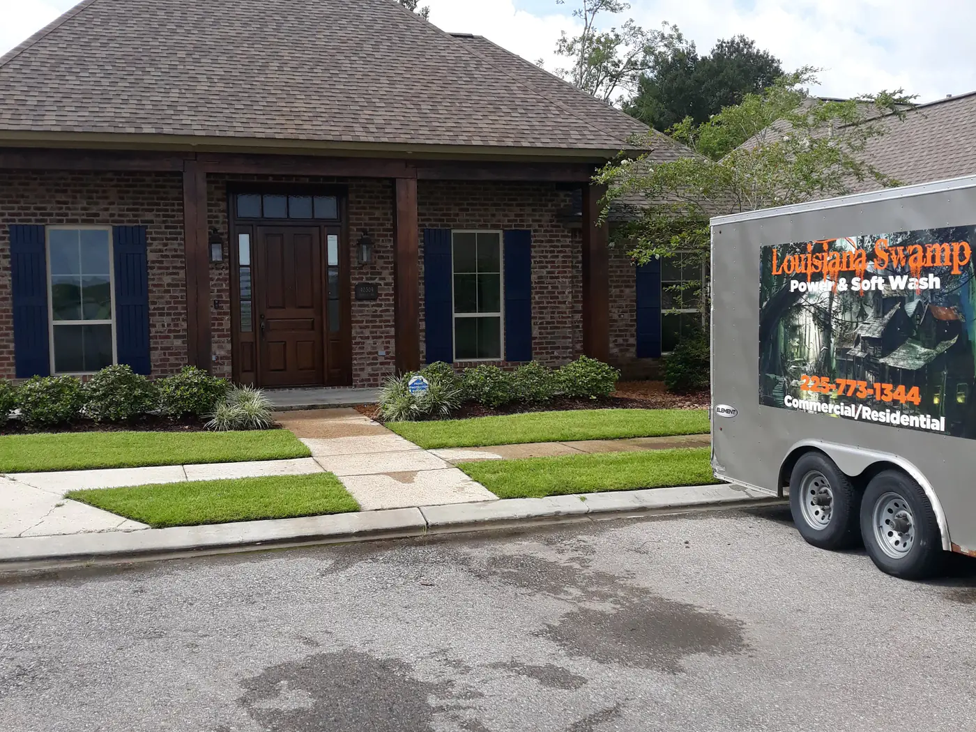 The same shingle roof after a low-pressure soft wash, cleaned to an even color.