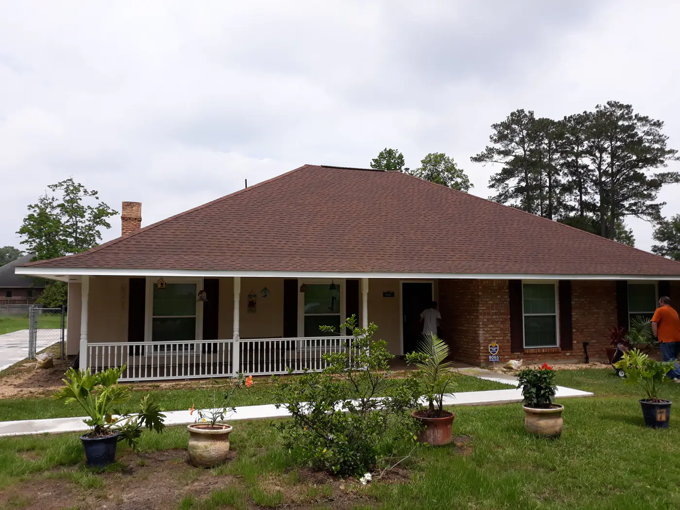 The same hip shingle roof after cleaning, with an even, lighter color.