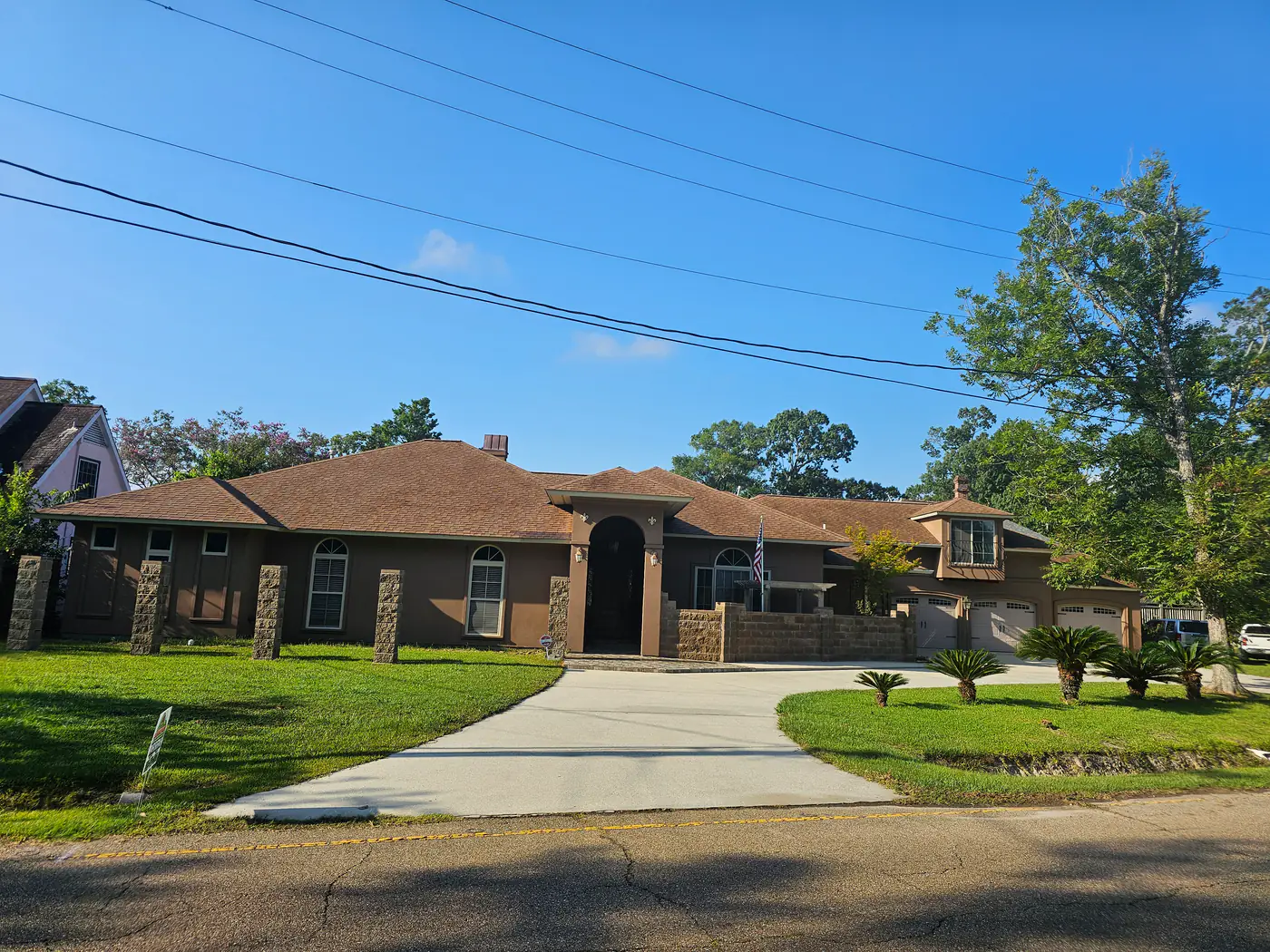 The same stucco home the next day with a cleaned, uniform roof.